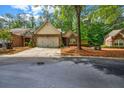 Charming brick home featuring a well-manicured lawn and a two-car garage at 3221 Abbott Dr # 5, Powder Springs, GA 30127