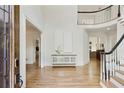 Bright foyer with wood floors, a curved staircase, and white trim at 5602 Asheforde Ln, Marietta, GA 30068