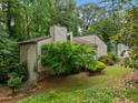 Home featuring beautiful greenery, with a stone foundation and wood siding at 766 Lost Creek Cir, Stone Mountain, GA 30088
