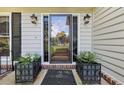 Home's front entrance features a glass door, sconces, and planters at 1487 W Bend Creek Ct, Atlanta, GA 30338