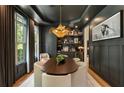 Sophisticated dining room featuring stylish lighting, dark walls, and a built-in bar for elegant entertaining at 3233 Osborne Ne Rd, Brookhaven, GA 30319