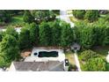 Aerial view of backyard featuring a dark, in-ground swimming pool and well manicured landscaping at 4663 Mossey Dr, Lithonia, GA 30038