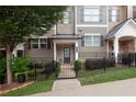 Charming townhome with landscaped front yard, gated entrance, and welcoming facade at 318 Lantana Ln, Woodstock, GA 30188