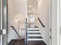 Welcoming foyer with hardwood floors, staircase, and neutral walls, offering a modern and stylish entry at 318 Lantana Ln, Woodstock, GA 30188