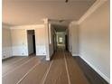 An open hallway features detailed trim work with gray flooring ready to be revealed at 5361 Tuscany Dr, Douglasville, GA 30135