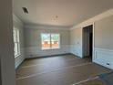 Bright living room showcasing decorative trim, neutral walls, and large windows for natural light at 5361 Tuscany Dr, Douglasville, GA 30135