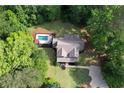 Aerial view of a home with a private pool and lush green surroundings at 6095 Fords Nw Rd, Acworth, GA 30101