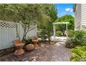 Private brick patio with seating and lush landscaping creating a peaceful outdoor space at 859 Scales Rd, Suwanee, GA 30024