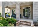 Inviting front porch with stone steps and a comfortable seating area at 859 Scales Rd, Suwanee, GA 30024