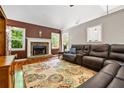 Comfortable living room with stone fireplace, hardwood floors, and natural light at 115 Bennett Farms Dr, Acworth, GA 30102