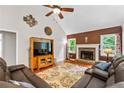 Cozy living room with vaulted ceiling, stone fireplace, and hardwood floors at 115 Bennett Farms Dr, Acworth, GA 30102