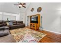 Open-concept living room with vaulted ceiling, hardwood floors, and large sectional sofa at 115 Bennett Farms Dr, Acworth, GA 30102