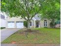 Lovely home with a manicured lawn, mature trees, and a convenient two-car garage at 2230 Laurel Lake Dr, Suwanee, GA 30024
