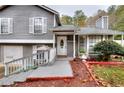 Inviting home entrance featuring a well-maintained yard and charming front porch at 2573 Mistletoe Ln, Snellville, GA 30039