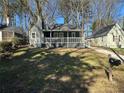 Charming gray home featuring a covered porch and a well-manicured lawn at 1457 Richland Sw Rd, Atlanta, GA 30310
