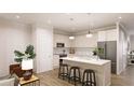 Bright, modern kitchen with stainless steel appliances, an island with seating, and ample counter space at 55 Alameda St # 6, Loganville, GA 30052