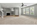 Bright and airy living room featuring a fireplace and large windows at 1995 Liberty Hts, Fairburn, GA 30213