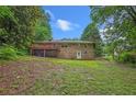 Lush backyard features a multi-level deck and a gently sloping lawn surrounded by mature trees at 3510 Dunn Se St, Smyrna, GA 30080