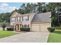 Attractive two-story house with a two-car garage, manicured lawn, and brick accents enhance curb appeal at 250 Kensington Trce, Stockbridge, GA 30281