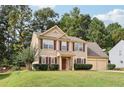 Charming two-story home featuring a well-manicured lawn and a two-car garage with traditional curb appeal at 250 Kensington Trce, Stockbridge, GA 30281