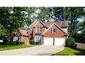 Beautiful two-story brick home with a two-car garage and a well-maintained lawn on a bright, sunny day at 2720 Stillwater Lake Ln, Marietta, GA 30066