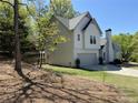 Two-story home featuring two-car garage, landscaped yard and chimney at 3040 Ivey Oaks Ln, Roswell, GA 30076