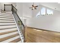 A bright living room features a high ceiling, hardwood floors, and stairway to the second floor at 3040 Ivey Oaks Ln, Roswell, GA 30076