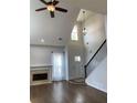 Inviting living room featuring a fireplace, hardwood floors, and staircase at 3040 Ivey Oaks Ln, Roswell, GA 30076
