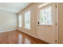 Bright entryway with hardwood floors, neutral walls, and a front door with sidelight windows at 4404 Village Field Pl, Suwanee, GA 30024