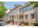 Charming townhome exterior showcasing a well-maintained facade, stairs to the entrance, and lush landscaping at 4404 Village Field Pl, Suwanee, GA 30024