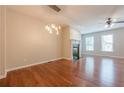 Open-concept living room featuring hardwood floors, a fireplace, and a modern chandelier at 4404 Village Field Pl, Suwanee, GA 30024