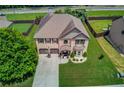 Aerial view of a beautiful two-story home with a large yard in a suburban neighborhood at 206 Traditions Dr, Loganville, GA 30052