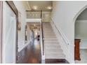Grand foyer with hardwood floors, a staircase, and an open view of the living spaces at 206 Traditions Dr, Loganville, GA 30052