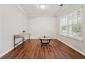 Small office space with hardwood floors, bright window, and light gray walls at 3569 Tupelo Trl, Auburn, GA 30011
