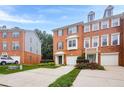 A well-maintained brick townhome featuring attached garages and landscaped front yards at 5589 Trace Views Dr, Norcross, GA 30071