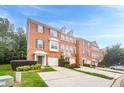Attractive brick townhome exterior with attached garages and well-maintained front yard landscaping at 5589 Trace Views Dr, Norcross, GA 30071