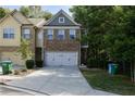 A charming two-story townhome with a brick facade and a two-car garage at 1547 Paxton Sw Dr, Lilburn, GA 30047