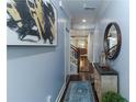 A view of the home's entry hallway with hardwood floors, decor, and modern light fixtures at 1547 Paxton Sw Dr, Lilburn, GA 30047