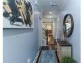 Inviting hallway featuring a glass floor detail, a decorative mirror, and stylish decor elements at 1547 Paxton Sw Dr, Lilburn, GA 30047