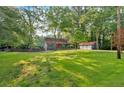 Expansive front yard with a well-maintained lawn and a detached three-car garage at 1731 Maryland Sw Ave, Marietta, GA 30008