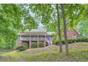 Beautiful two-story brick home with a covered porch and picturesque surroundings at 245 Sutallee Ridge Ne Ln, White, GA 30184
