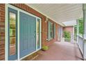 Inviting front porch with a blue door and a cozy 