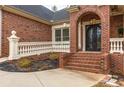 Home featuring an arched entryway with double doors and lovely brickwork at 4457 Equity Ct, Ellenwood, GA 30294