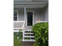 View of front entrance featuring a small porch and landscaping at 345 Staten St, Jonesboro, GA 30238