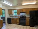 Functional kitchen with appliances, tile floors, and wooden cabinets at 345 Staten St, Jonesboro, GA 30238