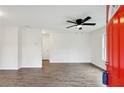 Bright living room featuring new floors, ceiling fan and a vibrant red door at 329 Cranfill Se Rd, Marietta, GA 30060