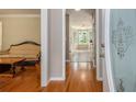 View of a home's entryway with hardwood floors and a glimpse into a living room and the kitchen at 4819 Elam Rd, Stone Mountain, GA 30083
