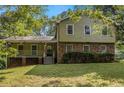 Charming home featuring brick accents, covered porch, a well-maintained lawn and inviting curb appeal at 4819 Elam Rd, Stone Mountain, GA 30083