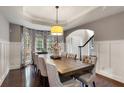 Formal dining room featuring a large wooden table, cushioned chairs, and elegant window treatments at 141 Ennisbrook Se Dr, Smyrna, GA 30082