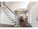 Bright foyer with hardwood floors, staircase, and an archway leading to the dining room at 141 Ennisbrook Se Dr, Smyrna, GA 30082